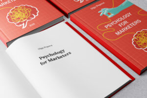Psychology for Marketers book cover held in hands
